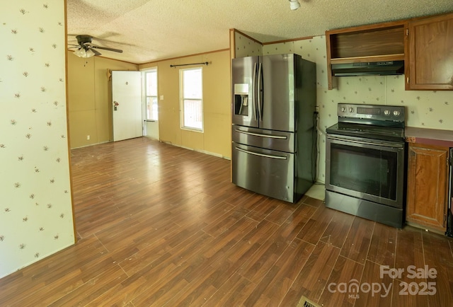 kitchen with appliances with stainless steel finishes, under cabinet range hood, and wallpapered walls