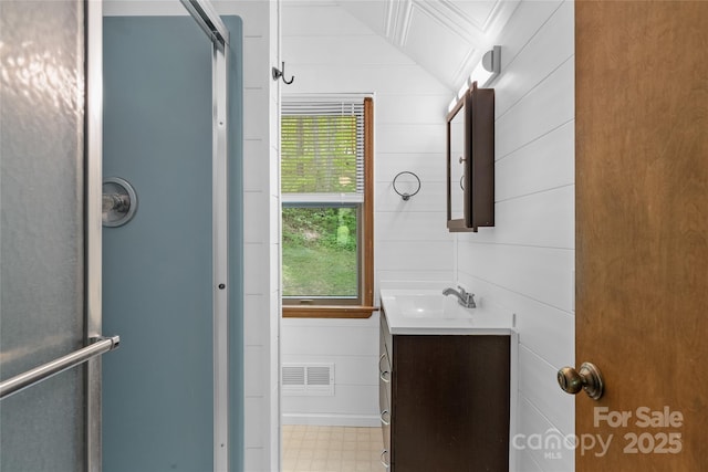 full bath with vanity, plenty of natural light, a shower stall, and visible vents