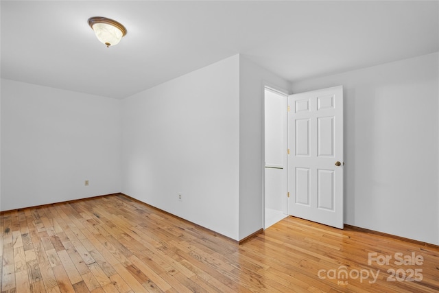 additional living space with baseboards and light wood finished floors
