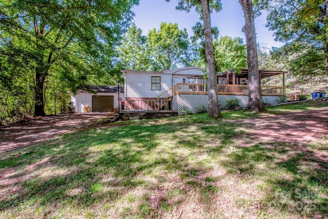 7733 Skyline Dr, Sherrills Ford, NC 28673 - view of green lawn with a wooden deck, an outdoor structure, driveway, and a garage