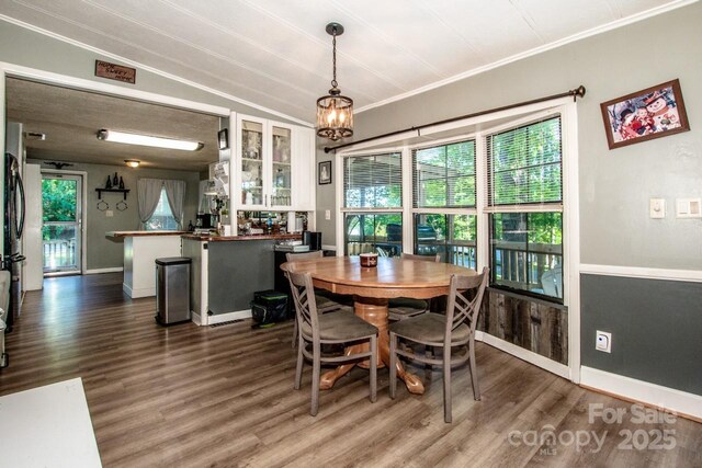 7733 Skyline Dr, Sherrills Ford, NC 28673 - dining space with healthy amount of natural light, dark wood-type flooring, and ornamental molding