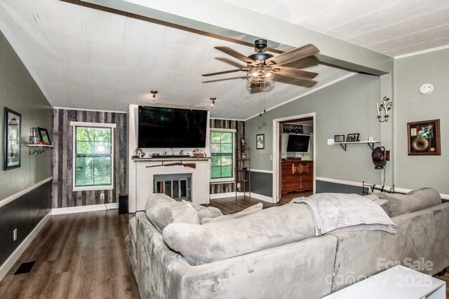 7733 Skyline Dr, Sherrills Ford, NC 28673 - living area featuring wood finished floors, vaulted ceiling, ceiling fan, baseboards, and a brick fireplace
