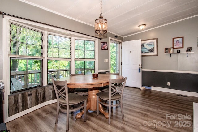 7733 Skyline Dr, Sherrills Ford, NC 28673 - dining area featuring wood finished floors, crown molding, a chandelier, and baseboards