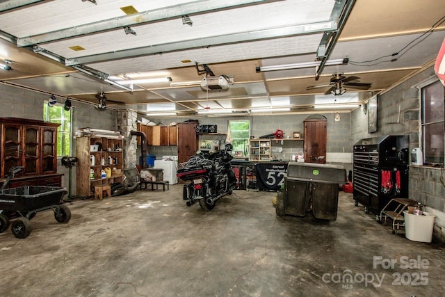 7733 Skyline Dr, Sherrills Ford, NC 28673 - garage with a workshop area, a garage door opener, and concrete block wall