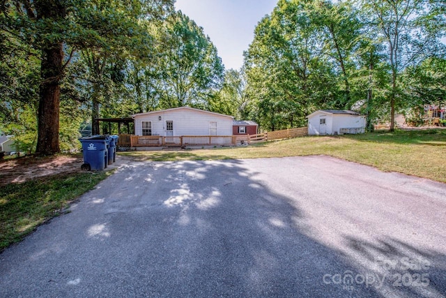 7733 Skyline Dr, Sherrills Ford, NC 28673 - exterior space featuring a wooden deck, an outbuilding, driveway, and view of wooded area