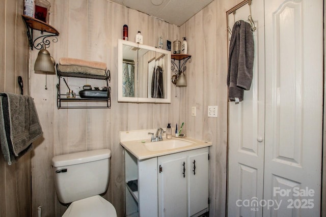 7733 Skyline Dr, Sherrills Ford, NC 28673 - bathroom featuring toilet, vanity, and wooden walls