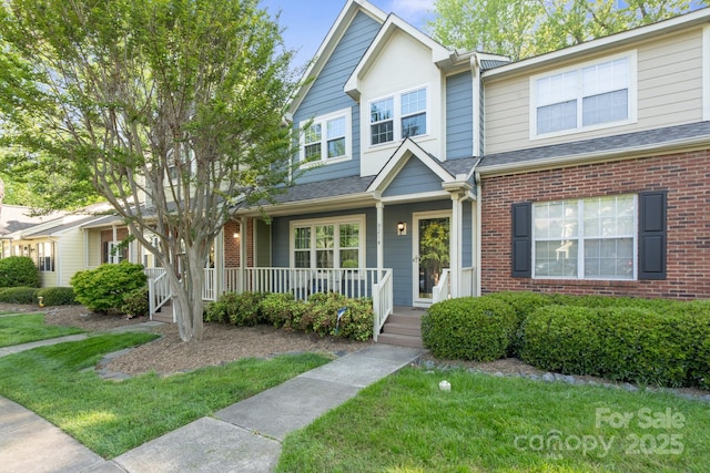 9214 Arbourgate Meadows Ln, Charlotte, NC 28277 - view of front of property with a porch, brick siding, and a front lawn
