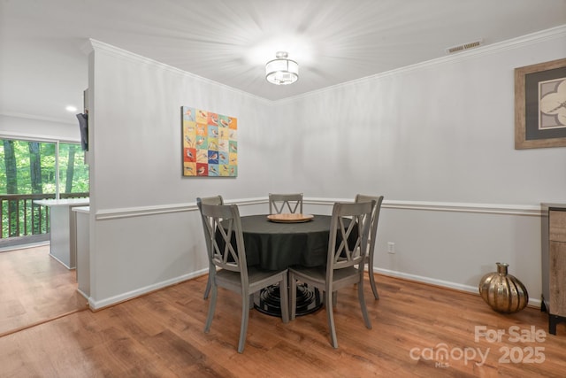 9214 Arbourgate Meadows Ln, Charlotte, NC 28277 - dining room featuring crown molding, baseboards, visible vents, and wood finished floors