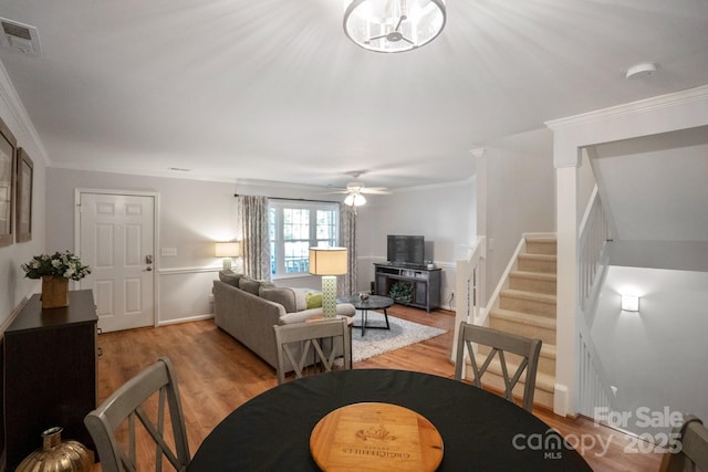 9214 Arbourgate Meadows Ln, Charlotte, NC 28277 - living area featuring visible vents, light wood-type flooring, stairway, baseboards, and ornamental molding