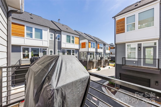 exterior space with a residential view and a grill