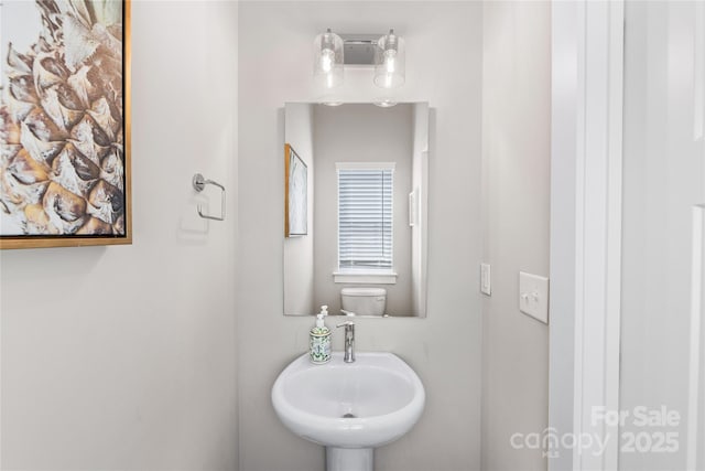 half bath with a sink and toilet