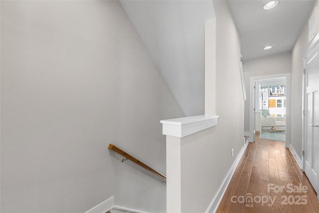 corridor with recessed lighting, baseboards, an upstairs landing, and hardwood / wood-style flooring