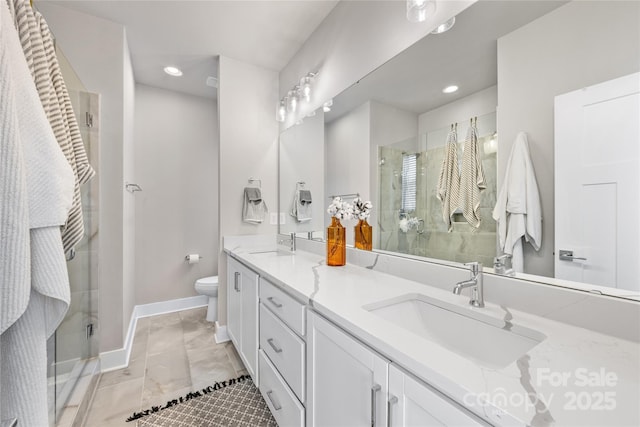 bathroom with recessed lighting, a sink, and a stall shower