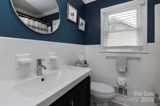 1514 Wensley Dr, Charlotte, NC 28210 - full bathroom with ornamental molding, vanity, toilet, wainscoting, and tile walls