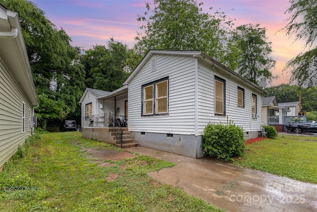 2622 Hemphill St, Charlotte, NC 28208 - property exterior at dusk with crawl space, a lawn, and covered porch