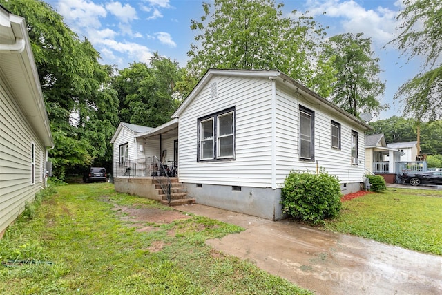 2622 Hemphill St, Charlotte, NC 28208 - view of property exterior featuring crawl space, a lawn, and covered porch