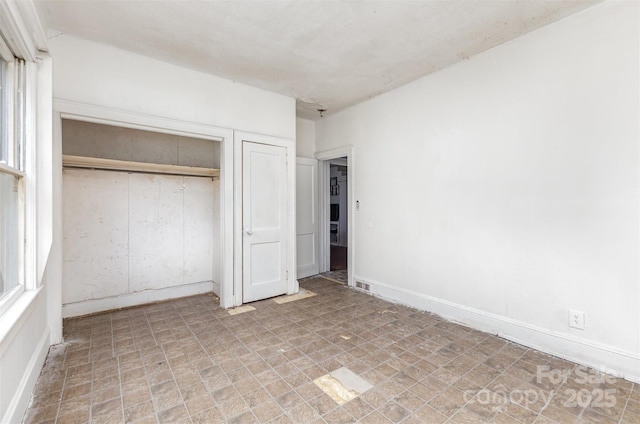 2622 Hemphill St, Charlotte, NC 28208 - unfurnished bedroom with tile patterned floors and a closet