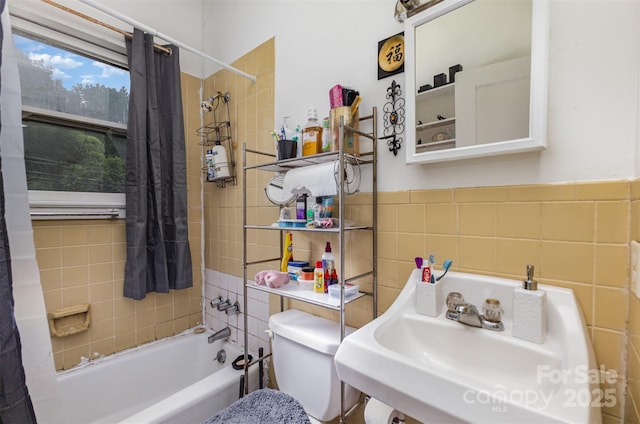 2622 Hemphill St, Charlotte, NC 28208 - full bath featuring tile walls, a sink, toilet, shower / bath combo, and a wainscoted wall