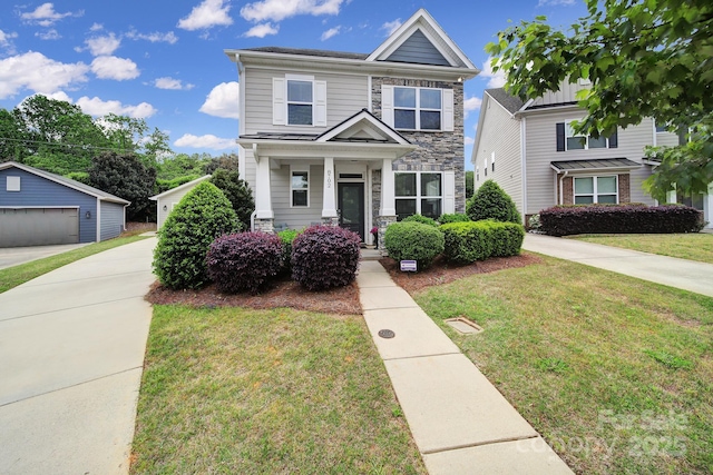 8702 Aspinwall Dr, Charlotte, NC 28216 - view of front facade featuring stone siding, an outdoor structure, a front yard, and a porch