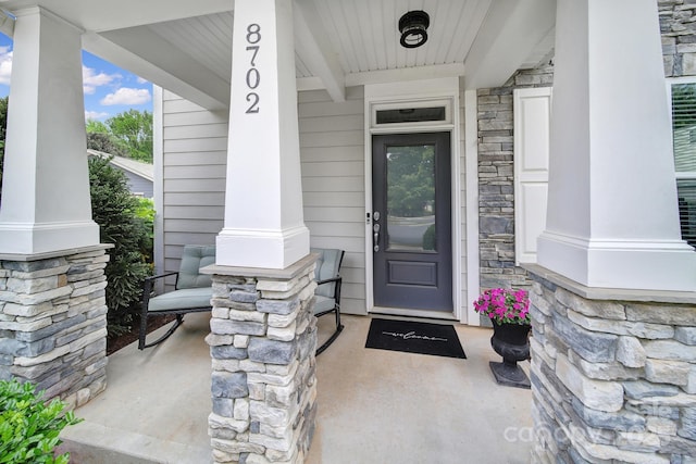 8702 Aspinwall Dr, Charlotte, NC 28216 - property entrance featuring a porch and stone siding