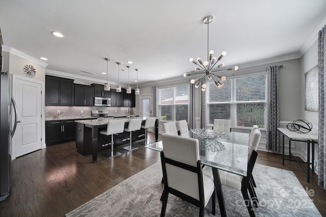 8702 Aspinwall Dr, Charlotte, NC 28216 - dining space featuring ornamental molding, a chandelier, recessed lighting, and dark wood finished floors