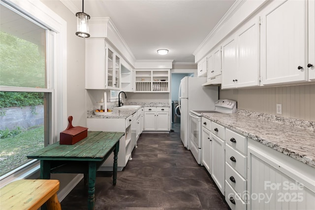 kitchen with a sink, under cabinet range hood, electric range, and white cabinetry