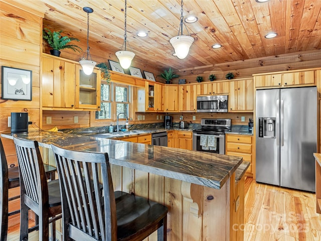 kitchen featuring stainless steel appliances, a peninsula, a sink, wooden ceiling, and light wood-type flooring
