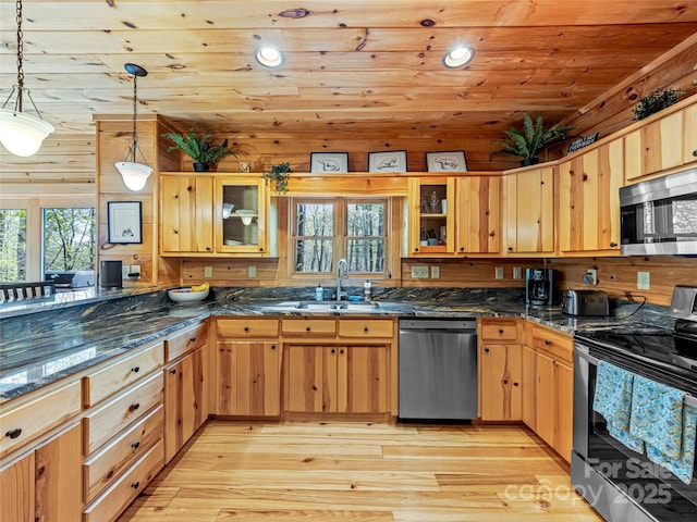 kitchen featuring stainless steel appliances, a sink, wood ceiling, glass insert cabinets, and light wood-type flooring