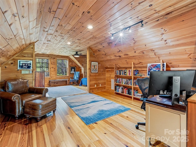 office space with wood walls, lofted ceiling, hardwood / wood-style floors, and wooden ceiling
