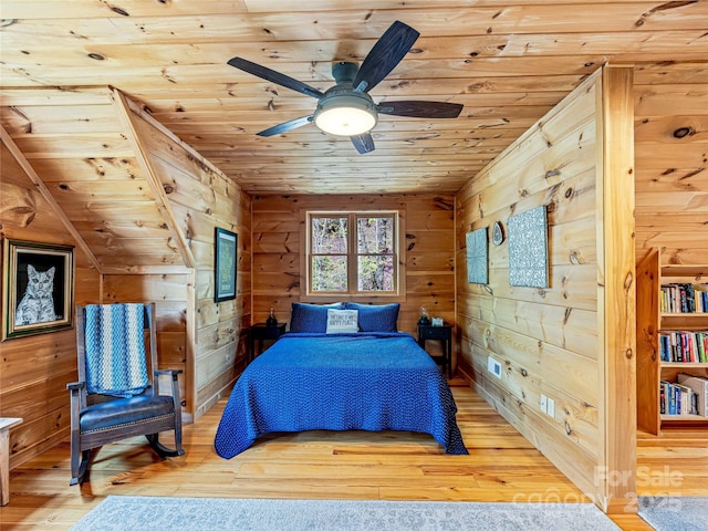 bedroom with wood ceiling, wood walls, wood finished floors, and ceiling fan