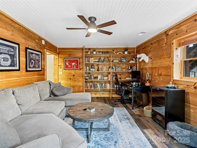 living area with wooden walls, ceiling fan, a desk, wood finished floors, and wooden ceiling
