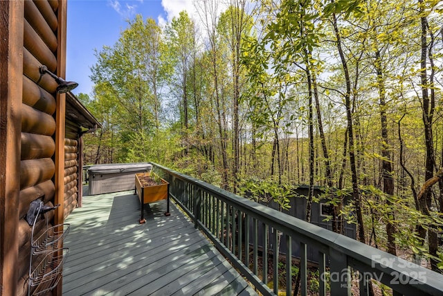 wooden terrace with a hot tub