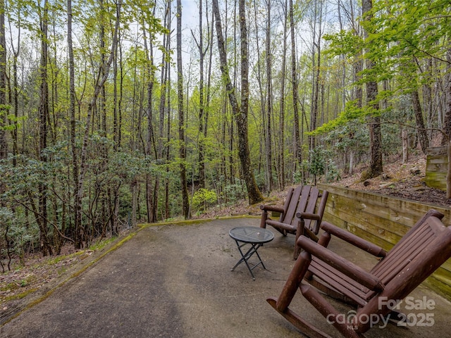 view of patio featuring a view of trees