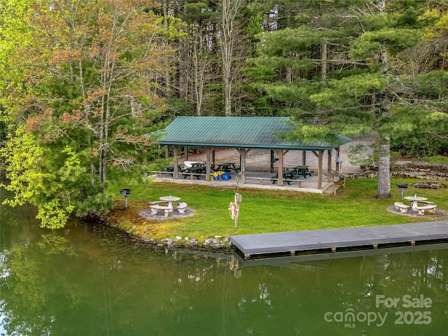 dock area featuring a fire pit, a gazebo, and a yard