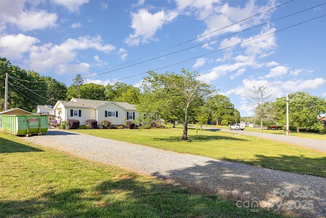 ranch-style home featuring driveway and a front yard