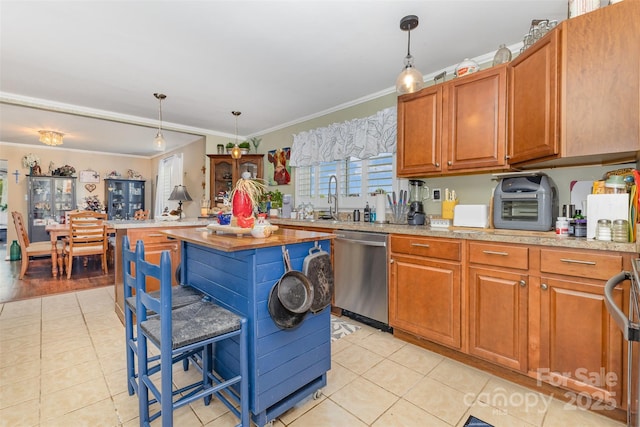 kitchen with dishwasher, ornamental molding, light tile patterned floors, a sink, and hanging light fixtures