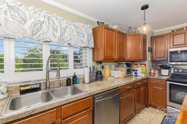 kitchen with appliances with stainless steel finishes, a sink, ornamental molding, healthy amount of natural light, and light countertops