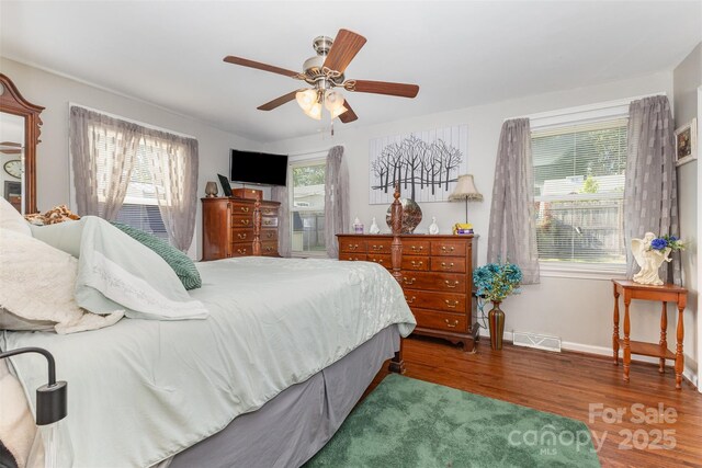 bedroom featuring wood finished floors, baseboards, and ceiling fan