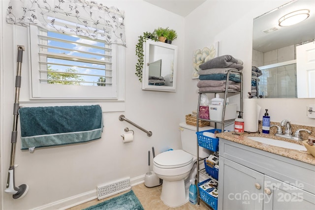 full bath featuring a stall shower, tile patterned floors, toilet, vanity, and baseboards