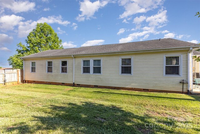 back of property with crawl space and roof with shingles