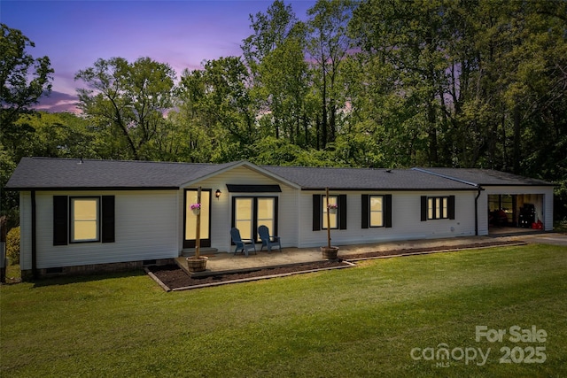 9 Ruby Dr, Hendersonville, NC 28792 - back of property at dusk with a lawn, roof with shingles, and an attached carport
