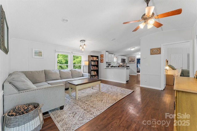 9 Ruby Dr, Hendersonville, NC 28792 - living area featuring crown molding, vaulted ceiling, baseboards, ceiling fan with notable chandelier, and dark wood-type flooring