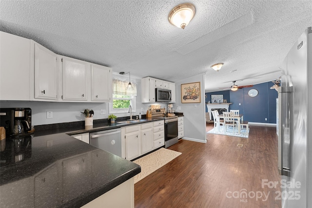 9 Ruby Dr, Hendersonville, NC 28792 - kitchen featuring ceiling fan, a textured ceiling, dark wood finished floors, white cabinets, and stainless steel appliances