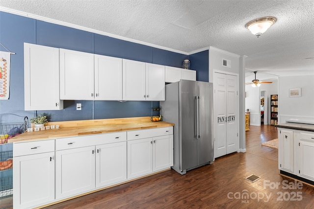 9 Ruby Dr, Hendersonville, NC 28792 - kitchen with a textured ceiling, visible vents, freestanding refrigerator, dark wood-style floors, and butcher block countertops