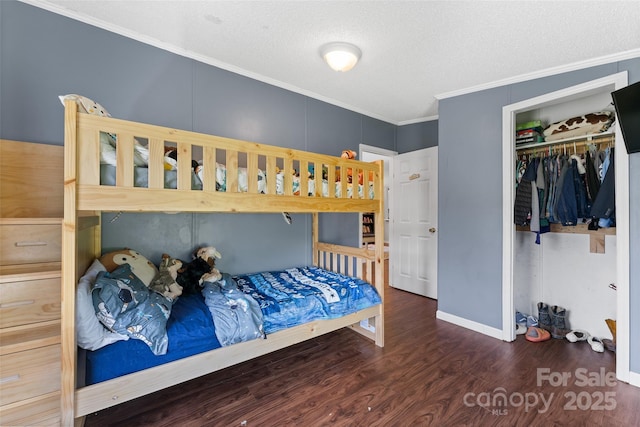 9 Ruby Dr, Hendersonville, NC 28792 - bedroom featuring ornamental molding, a closet, a textured ceiling, and wood finished floors