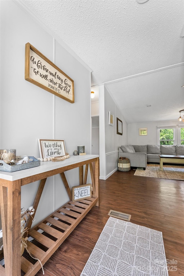 9 Ruby Dr, Hendersonville, NC 28792 - hall featuring a textured ceiling, vaulted ceiling, ornamental molding, and wood finished floors