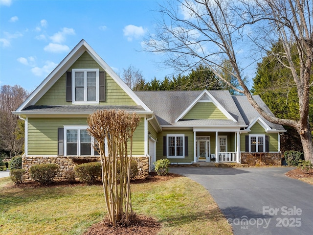 44 Chip Shot Ct, Mills River, NC 28759 - craftsman house with a porch, a front yard, aphalt driveway, a shingled roof, and stone siding