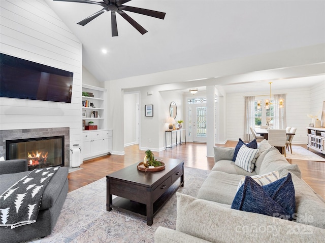 44 Chip Shot Ct, Mills River, NC 28759 - living area with ceiling fan with notable chandelier, wood finished floors, and a large fireplace