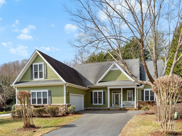 44 Chip Shot Ct, Mills River, NC 28759 - craftsman inspired home with an attached garage, a porch, driveway, and stone siding
