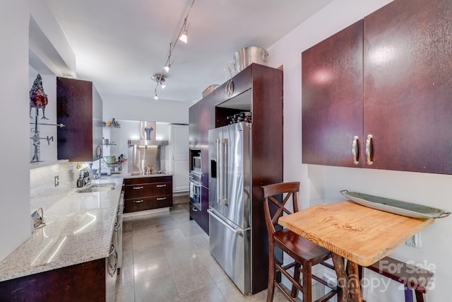 301 W 10th St W, Charlotte, NC 28202 - kitchen with stainless steel appliances, light stone countertops, a sink, light tile patterned floors, and track lighting